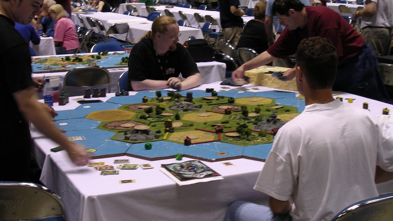 Players around an oversized Settlers of Catan board at Gen Con 2003
