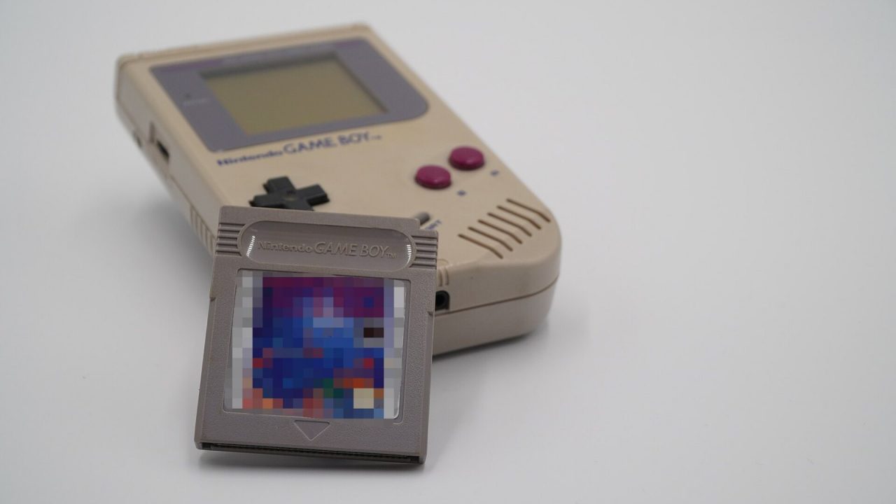 Original Nintendo Game Boy with a Tetris cartridge leaning against it