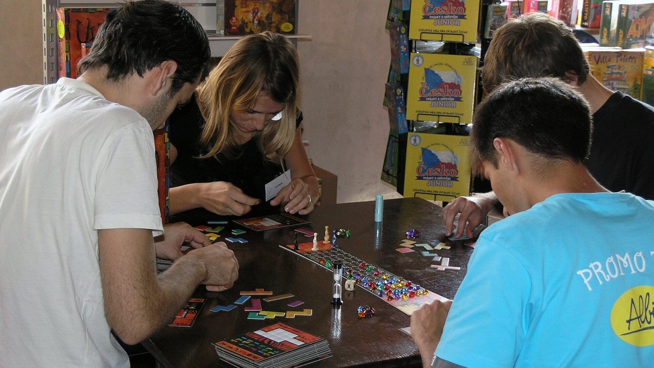 Players solving tile puzzles in Ubongo at the Hry a hlavolamy games and puzzles festival