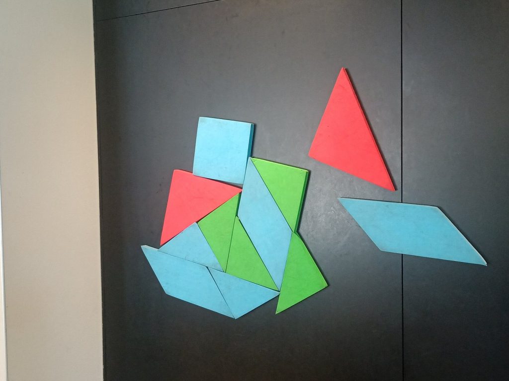 Magnetic tangram puzzle pieces arranged into a shape