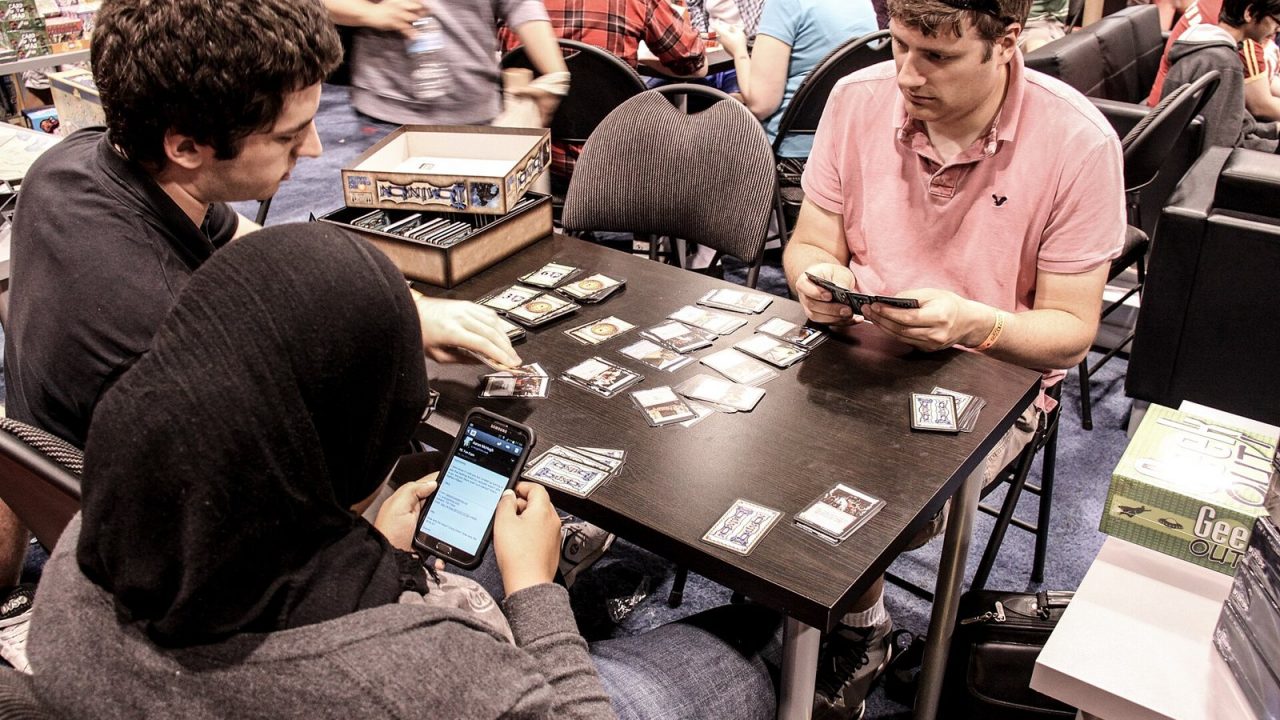 A Dominion card game in progress on a convention table